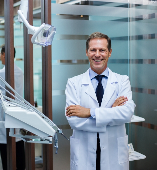 Confident dentist in white coat, symbolizing the professional satisfaction following a successful practice transition.