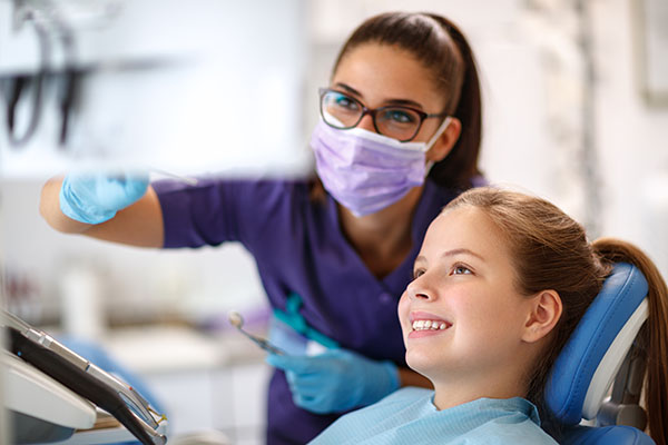 Pediatric dental consultation with child looking at monitor