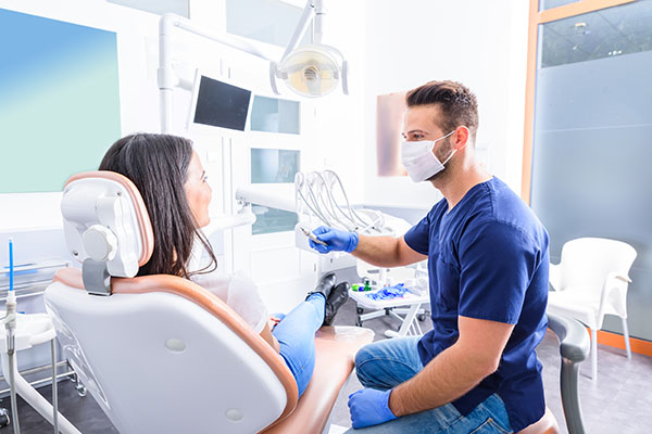 Dentist discussing treatment plan with patient in exam room