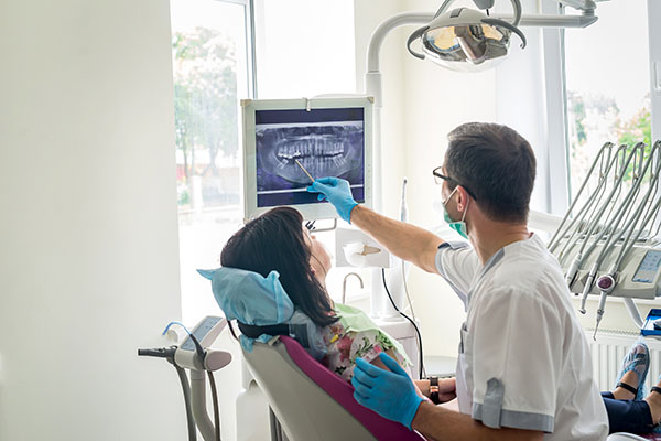 Dentist discussing x-ray findings with patient