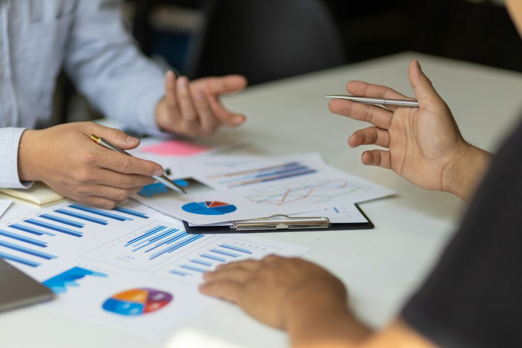 Dentist consulting with financial advisors on practice transition strategies in an office setting.